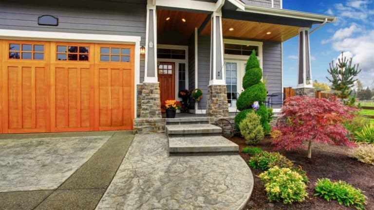 Suburban Curb Appeal small tree and bush garden next to unilocked paver driveway