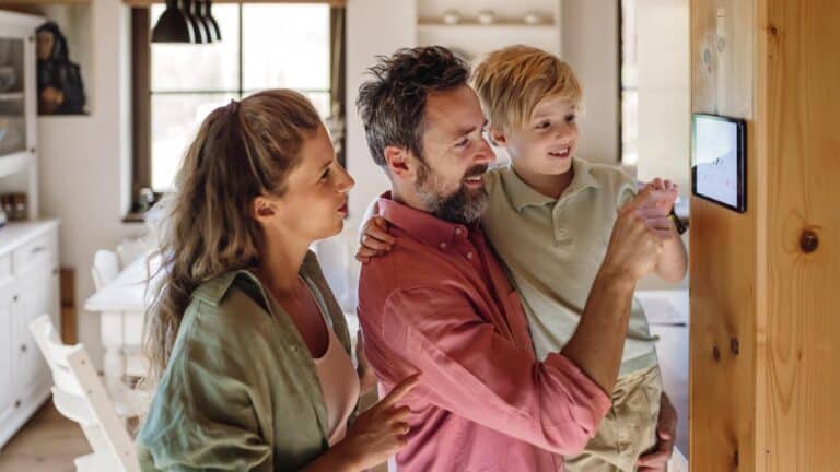 Family Gathered Around Thermostat